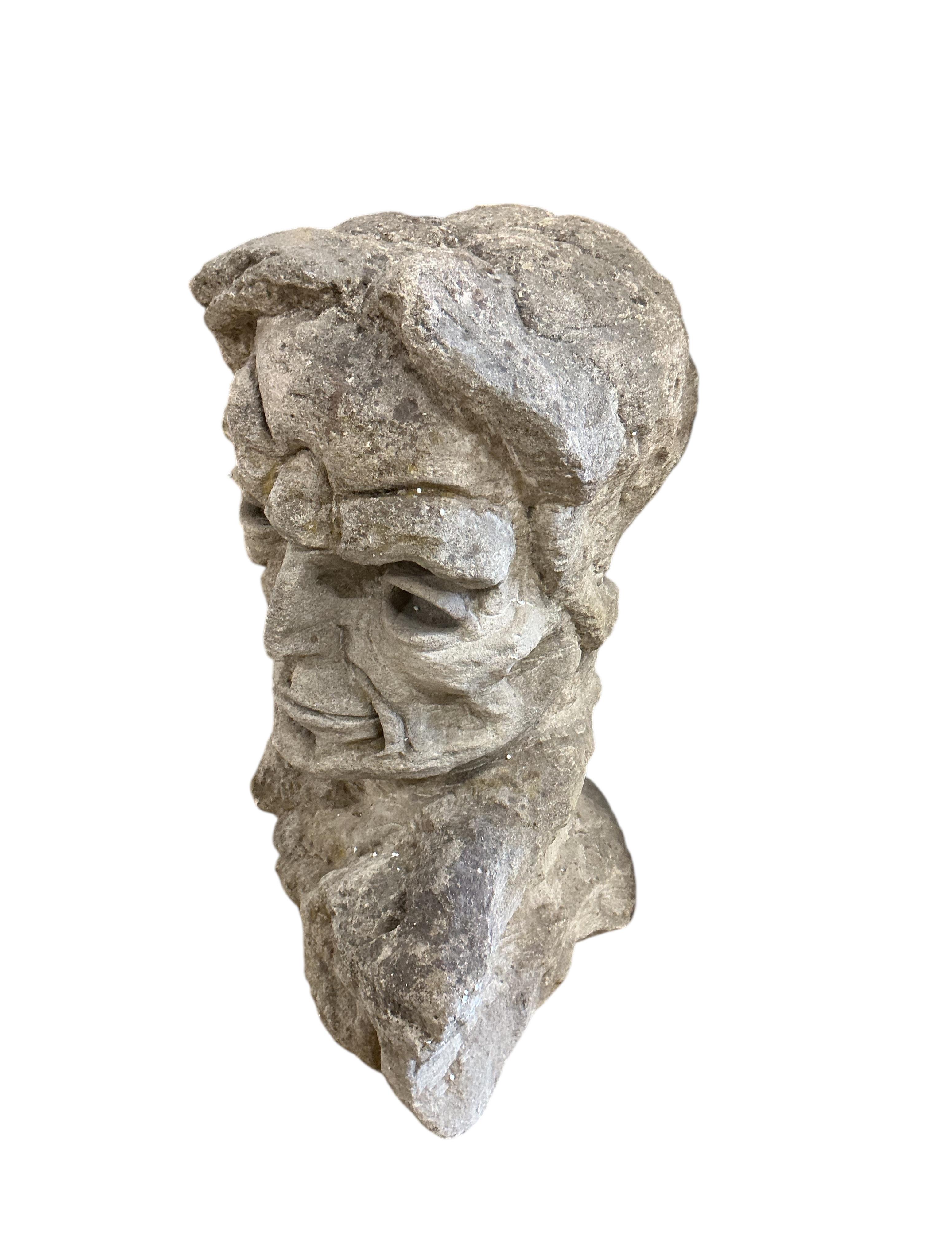 A carved stone head, height 69cm